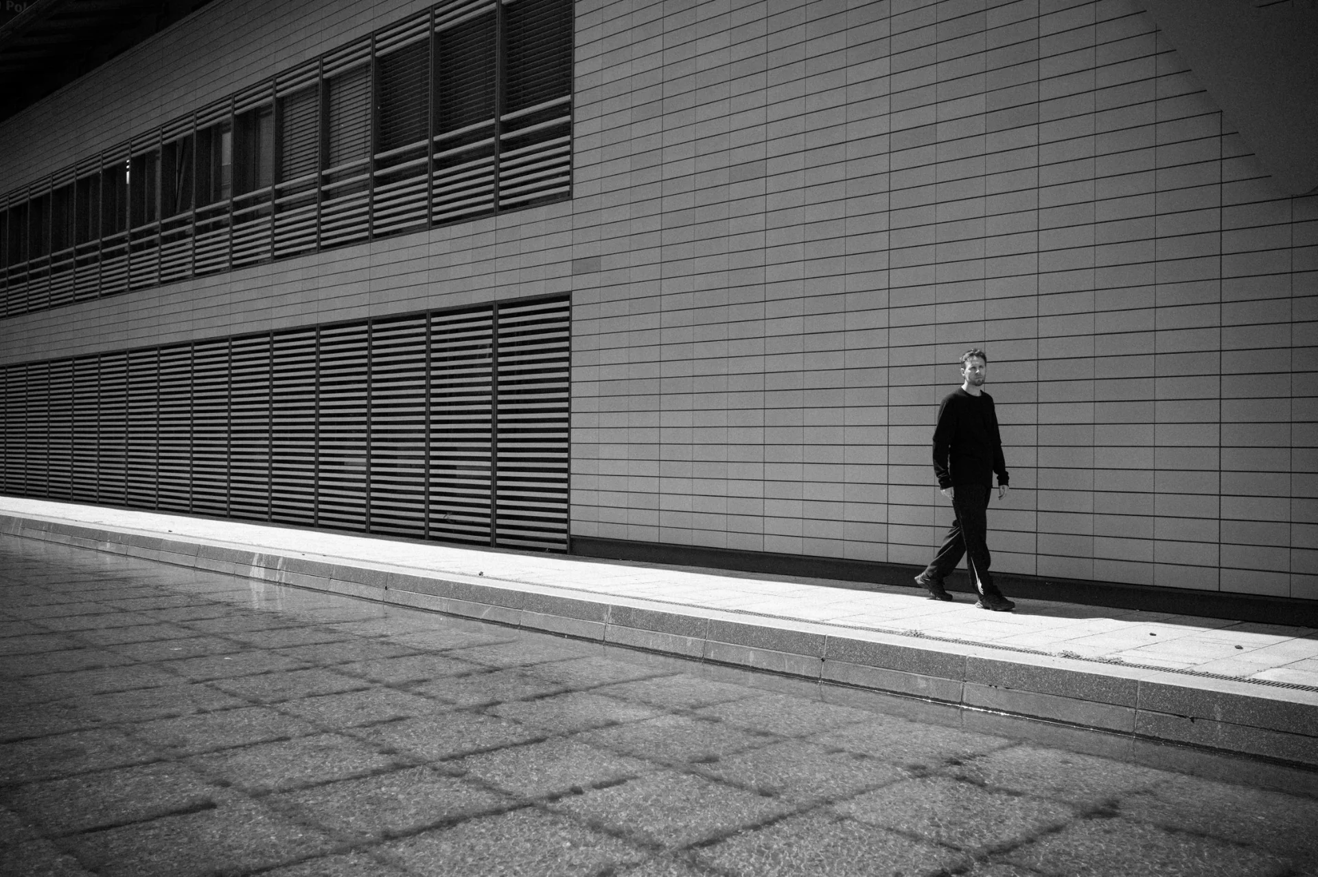 Andrea Viscardi walking through a modern architectural space